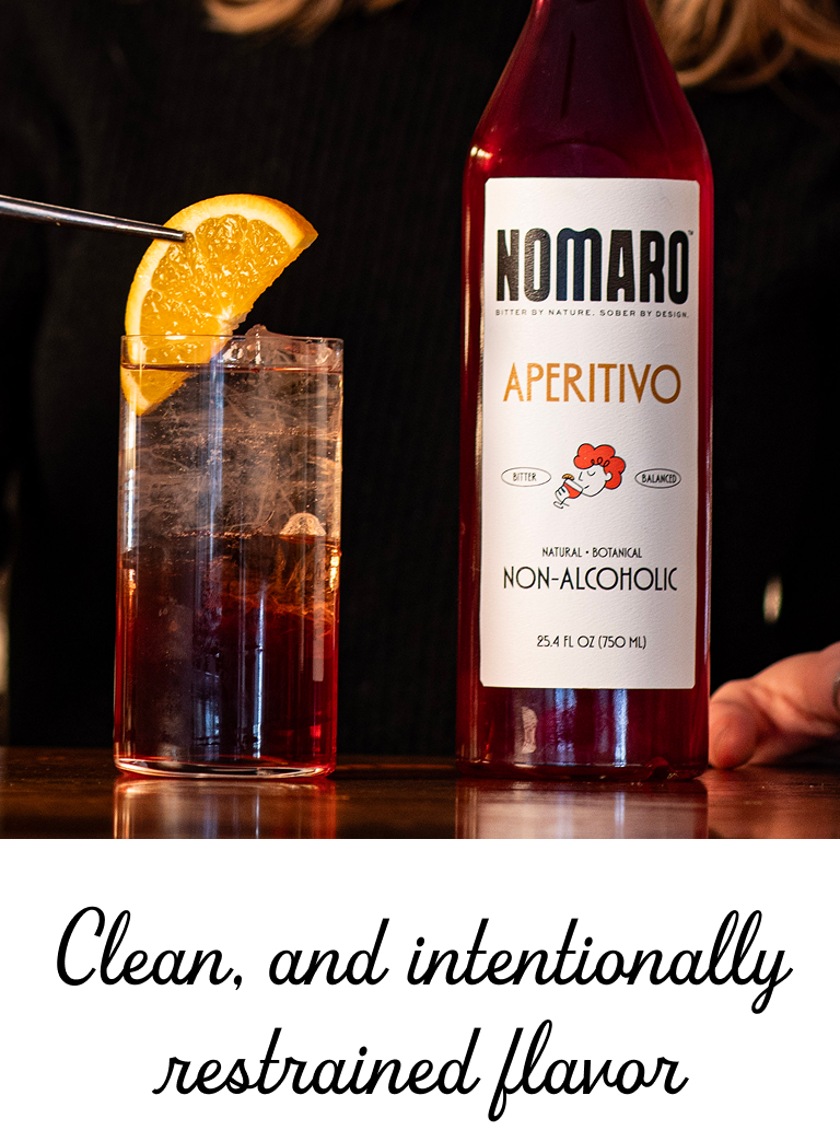 Nomaro Aperitivo bottle with a cocktail garnished with an orange slice on a wooden surface.